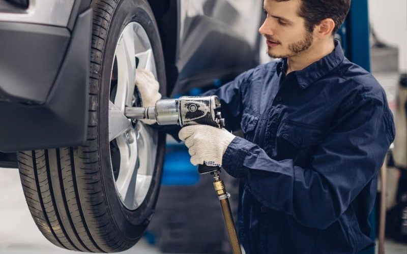 Service employee fixing a tire